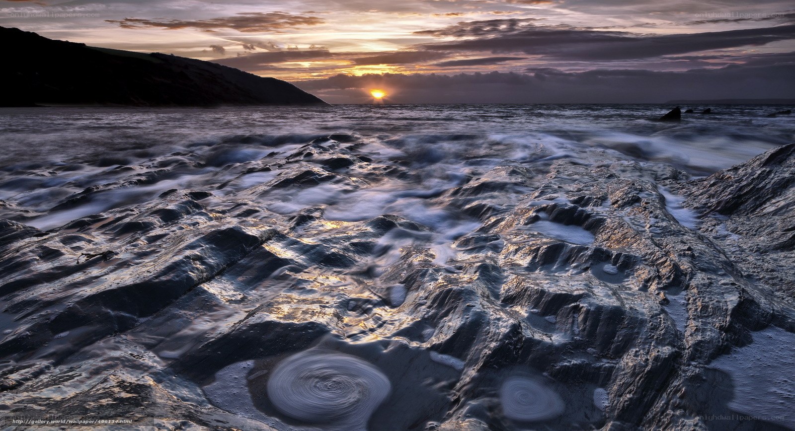 Sunset over rocky shoreline