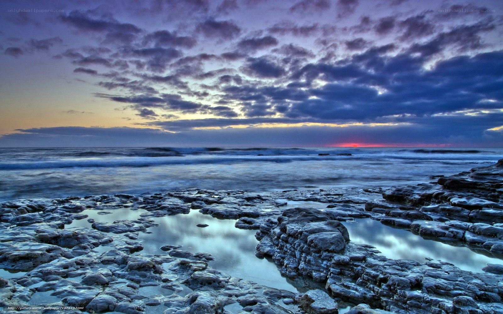 Sunset over rocky shoreline