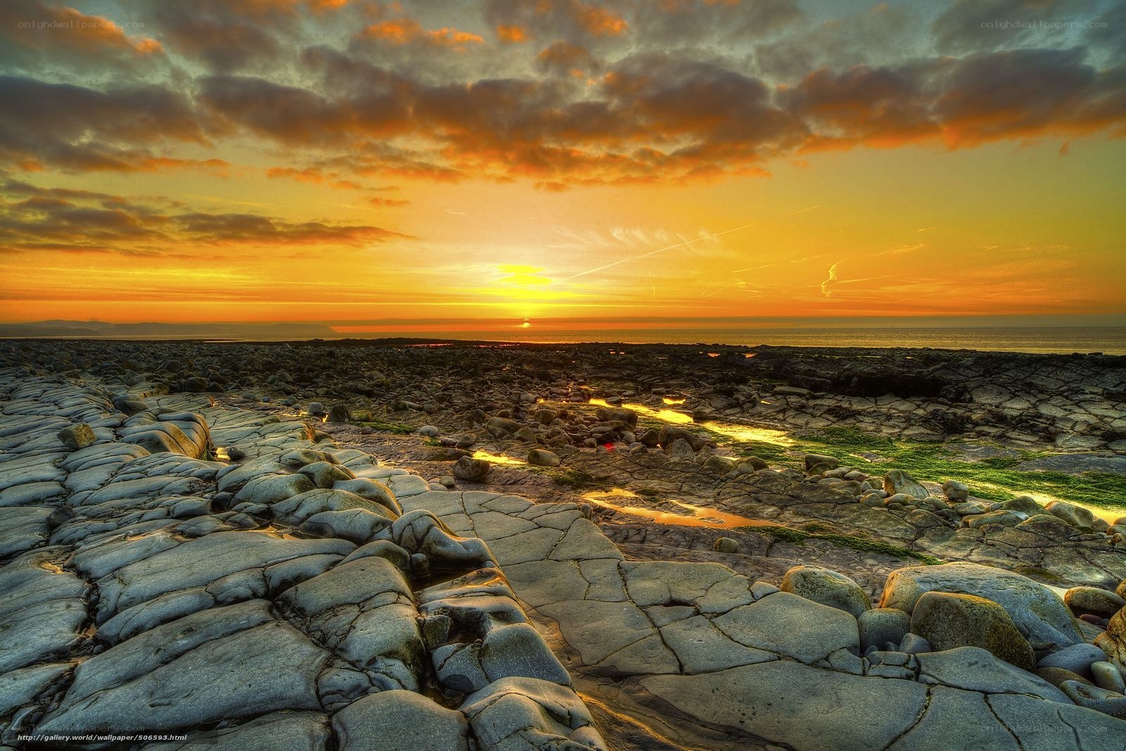 Sunset over rocky shoreline