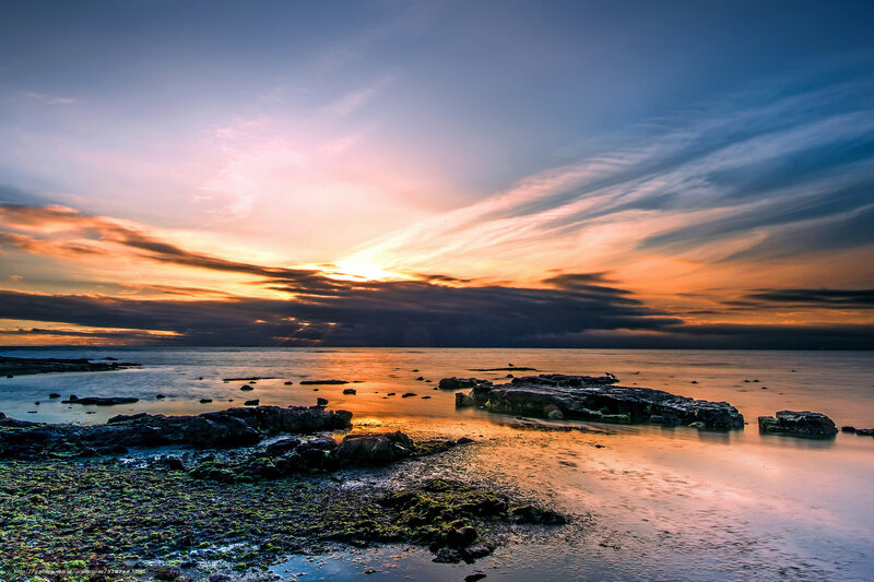 Sunset over rocky shoreline