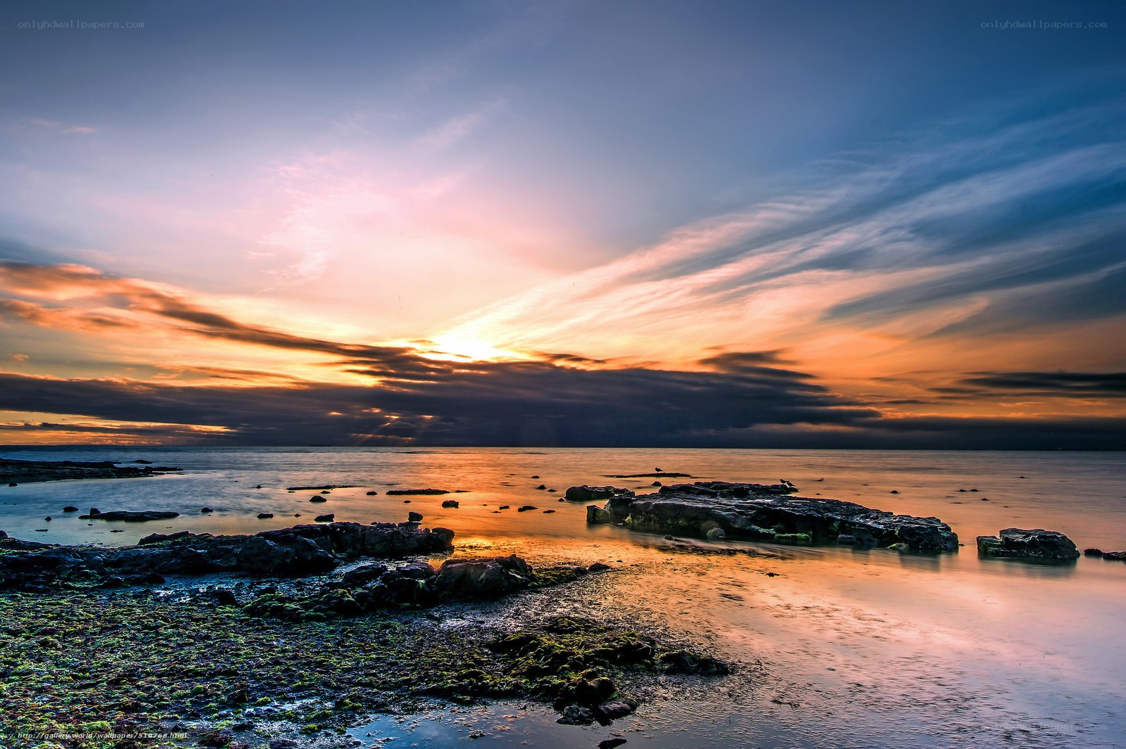 Sunset over rocky shoreline