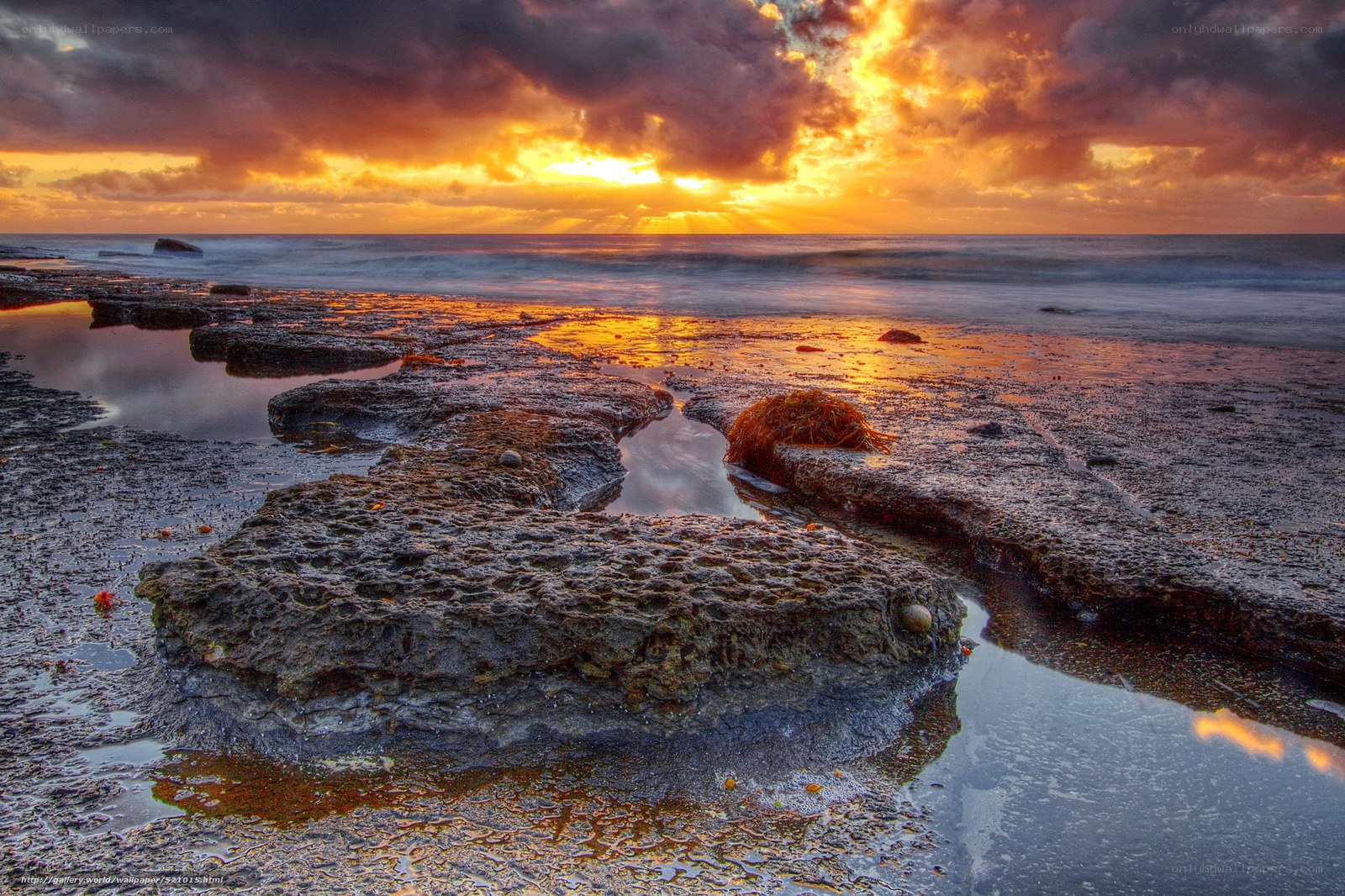 Sunset over rocky shoreline