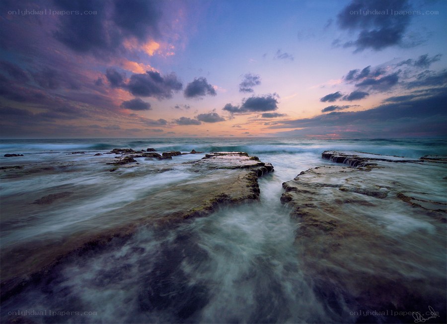 Sunset over rocky shoreline