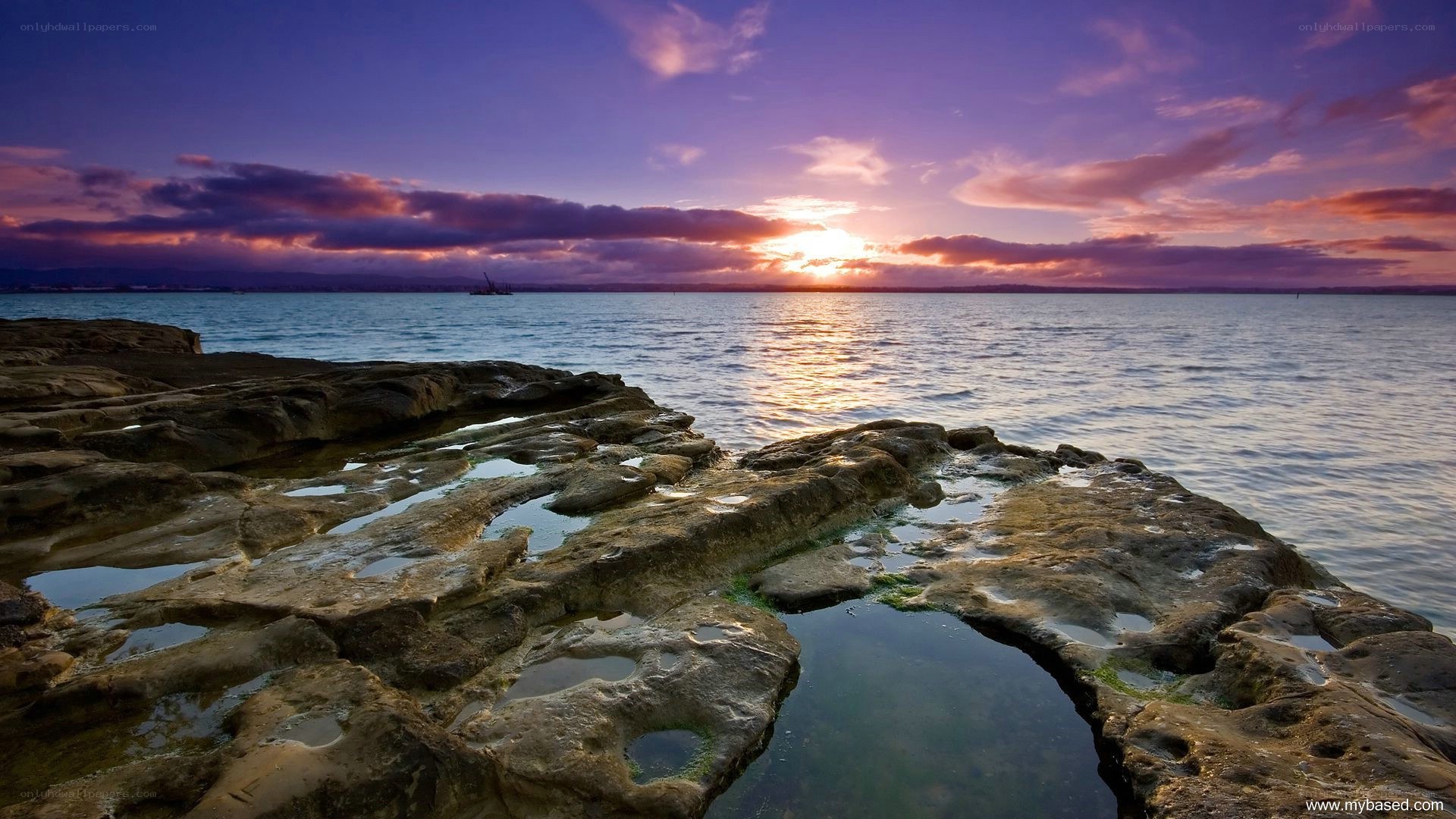 Sunset over rocky shoreline