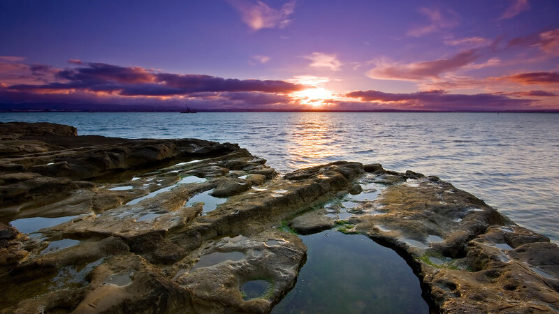 Sunset over rocky shoreline