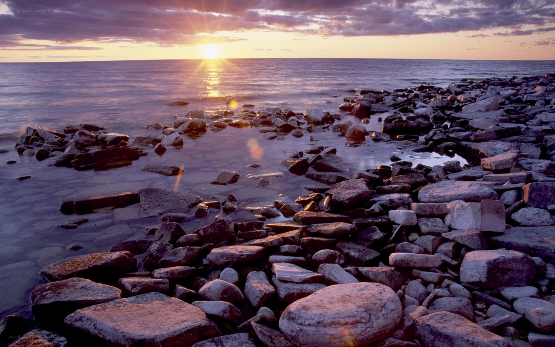 Sunset over rocky shoreline