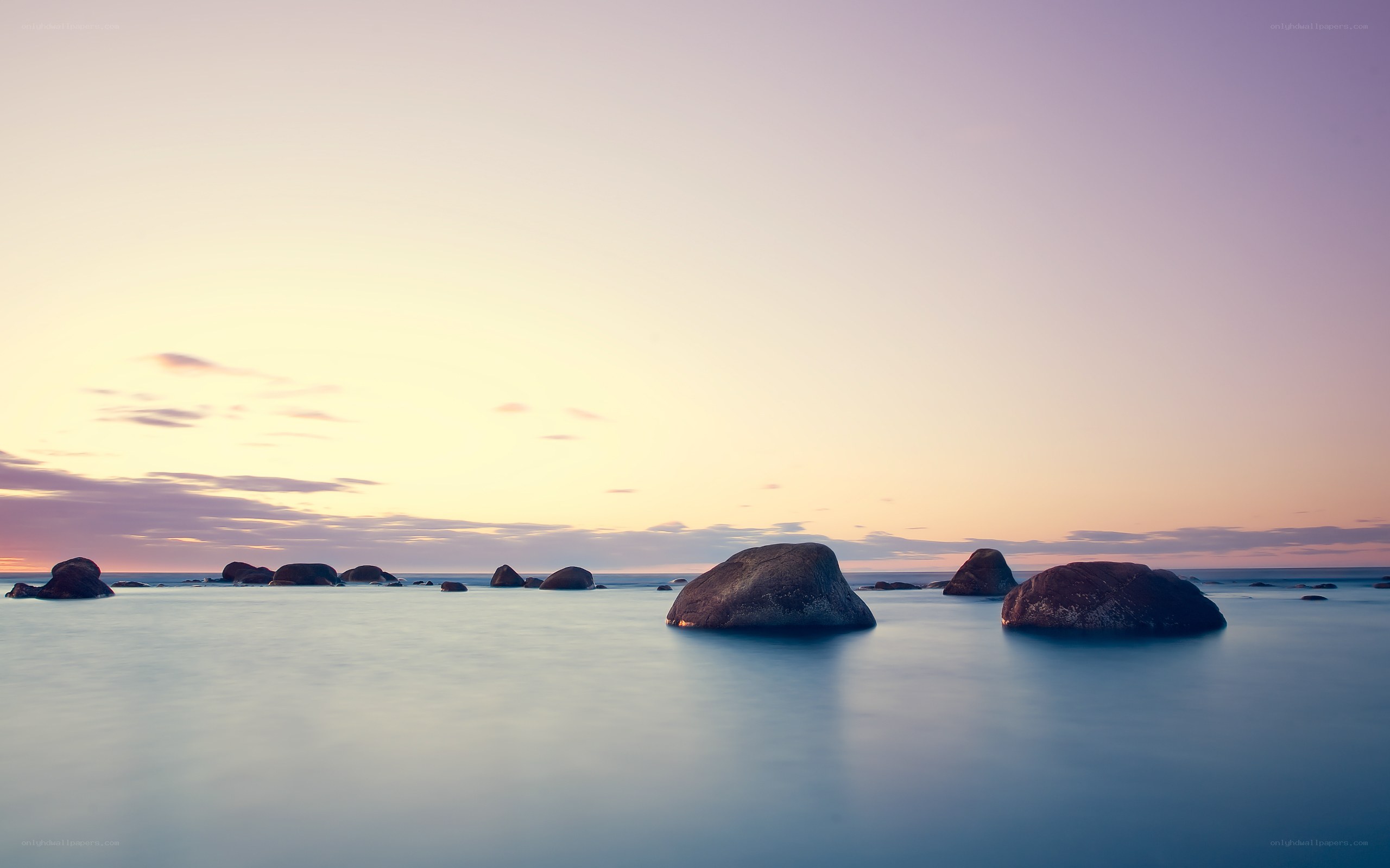 Sunset over rocky shoreline