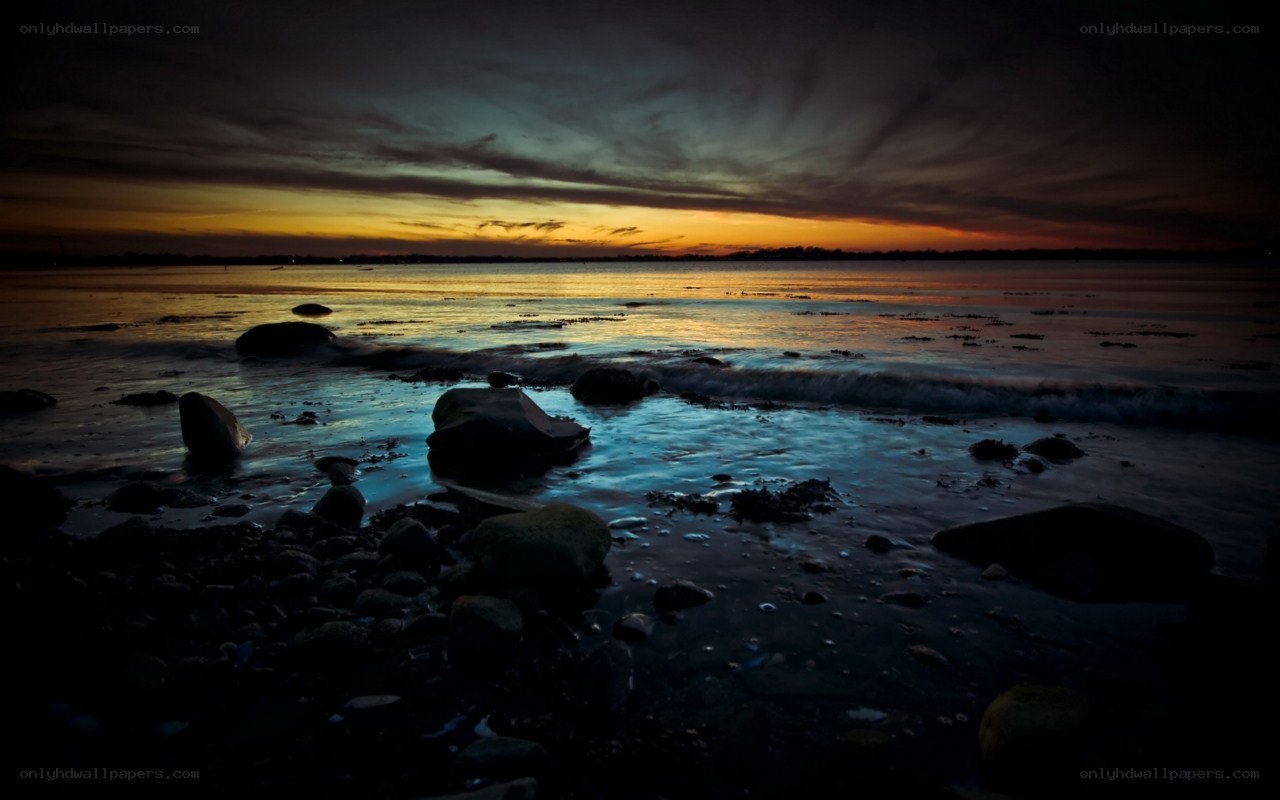 Sunset over rocky shoreline