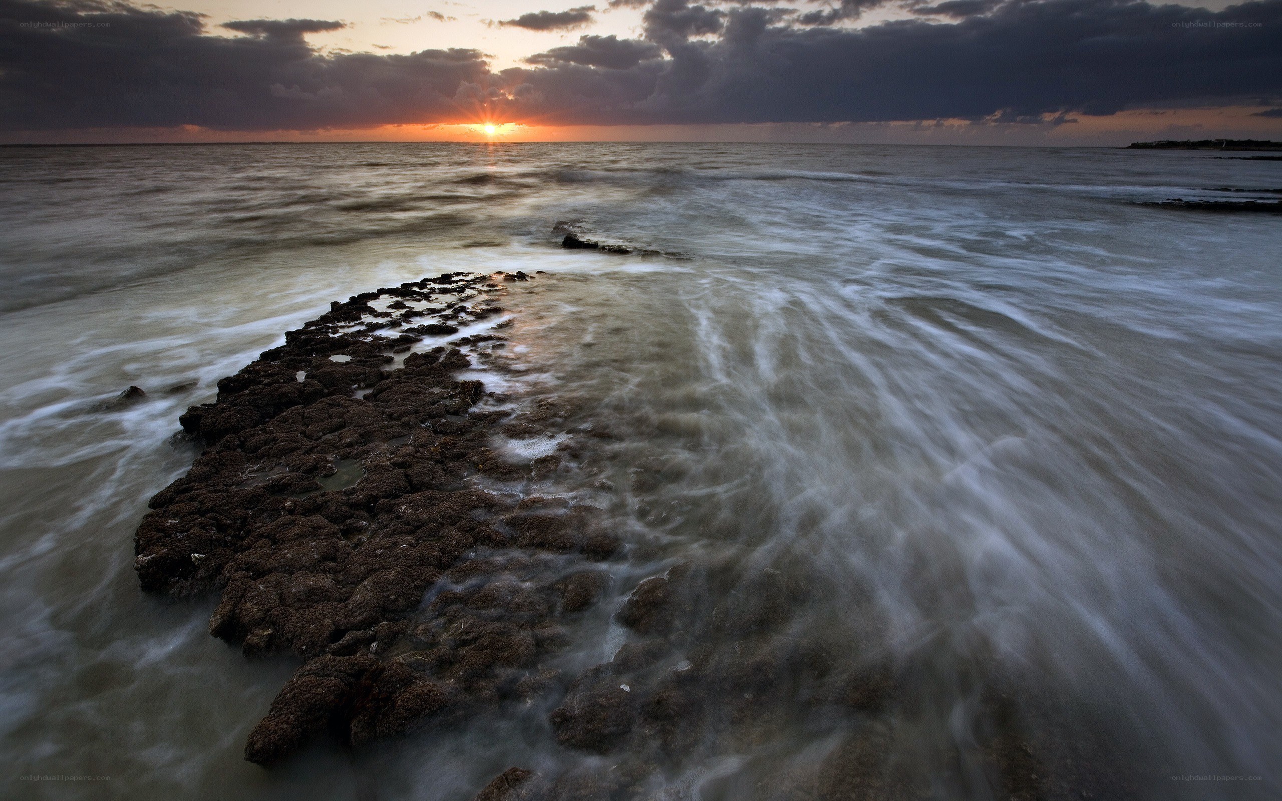 Sunset over rocky shoreline
