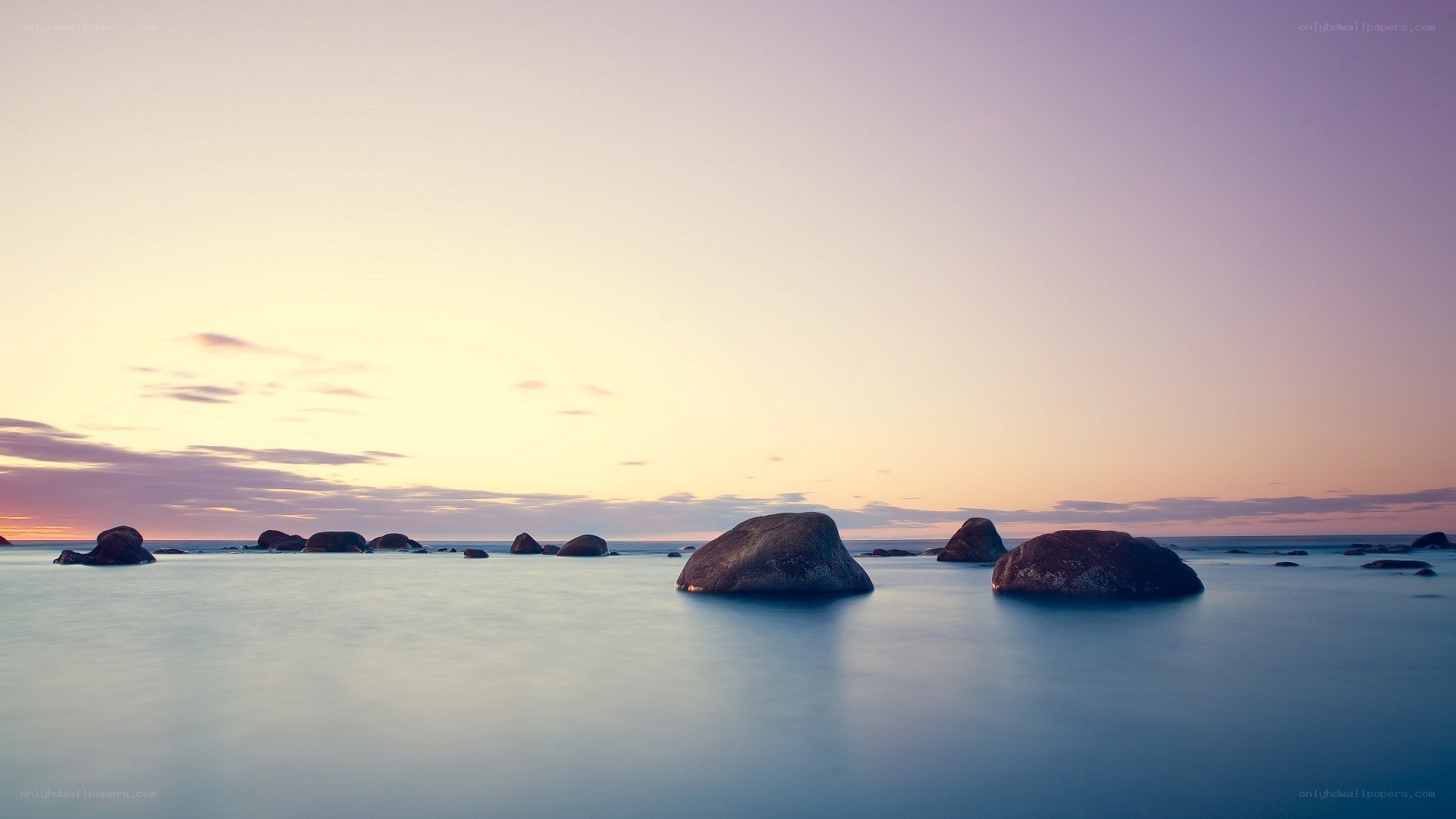 Sunset over rocky shoreline