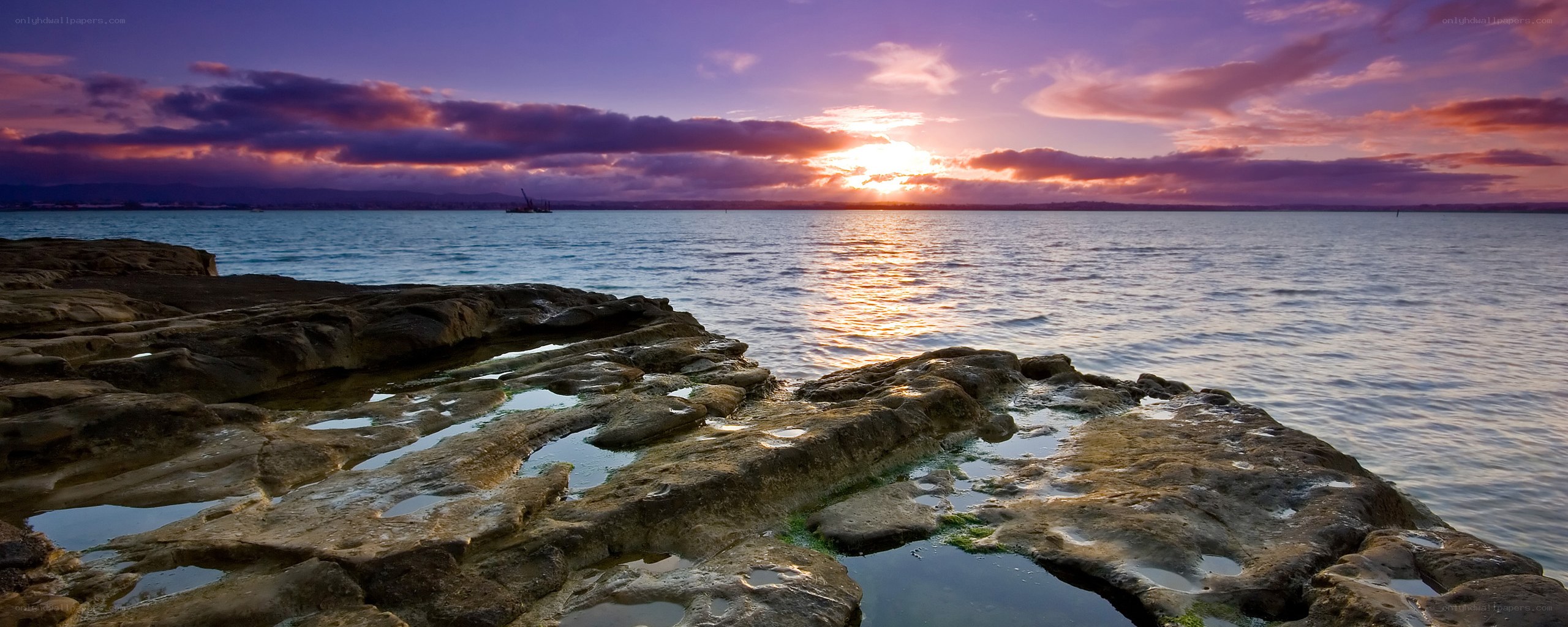Sunset over rocky shoreline