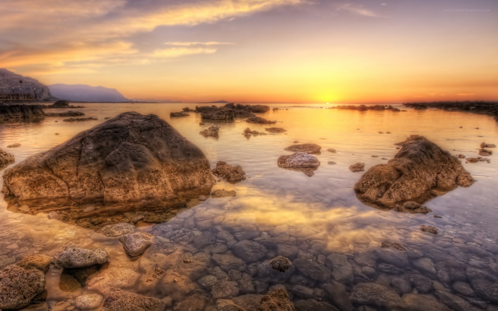 Sunset over rocky shoreline