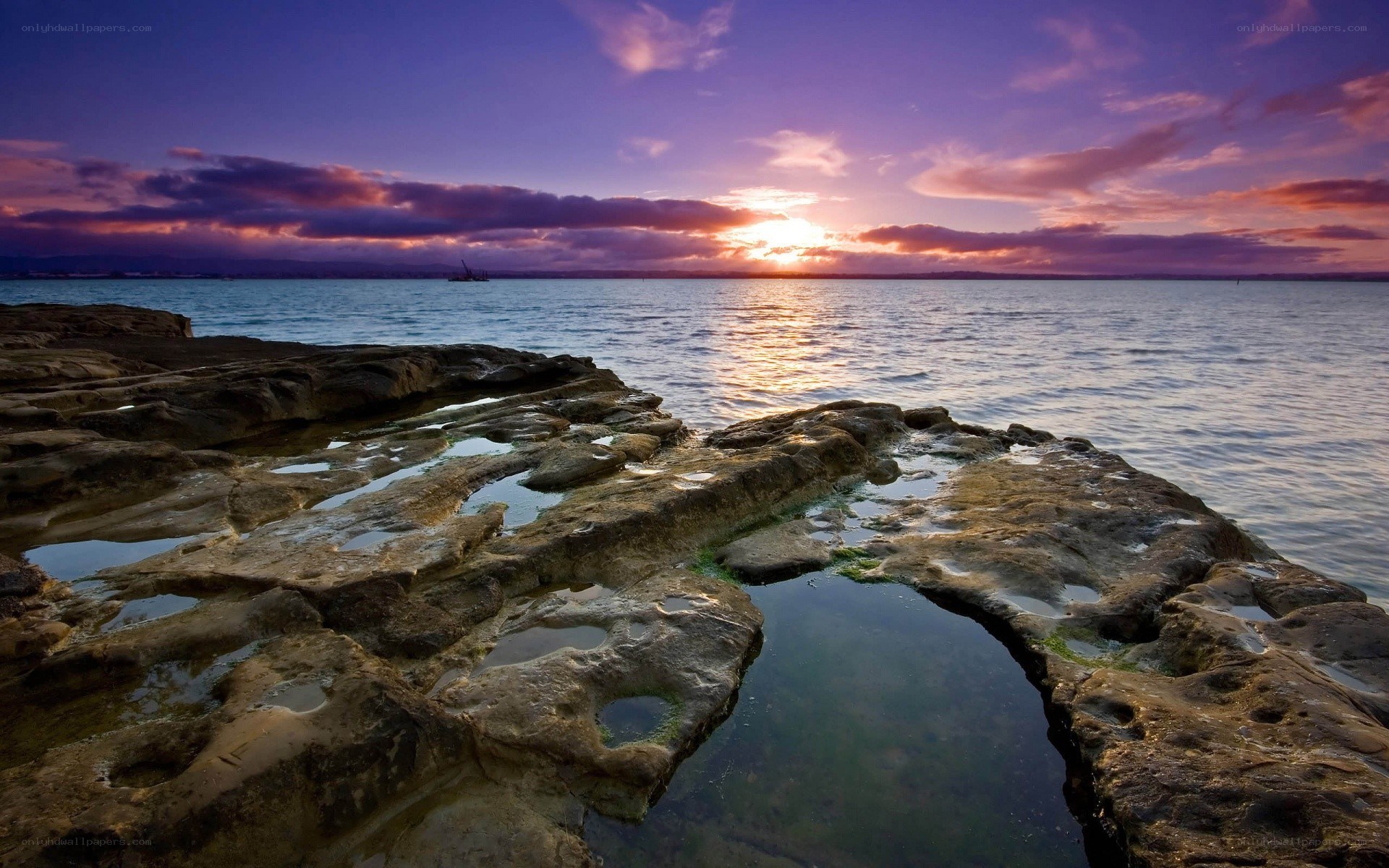 Sunset over rocky shoreline