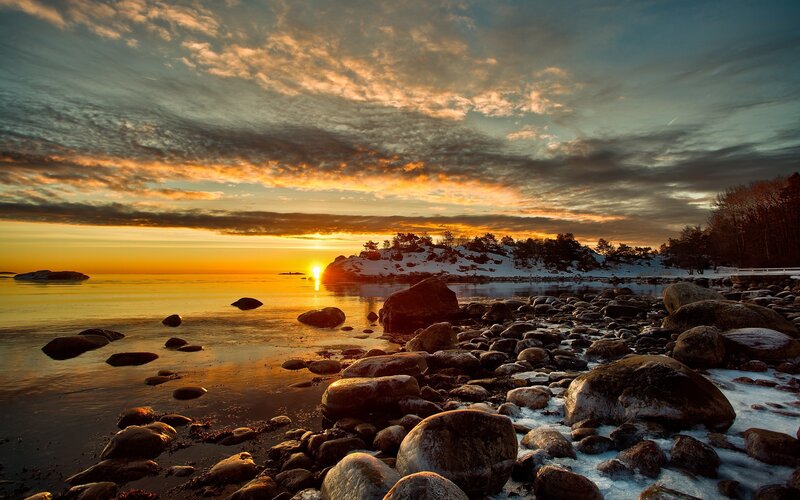Sunset over rocky shoreline