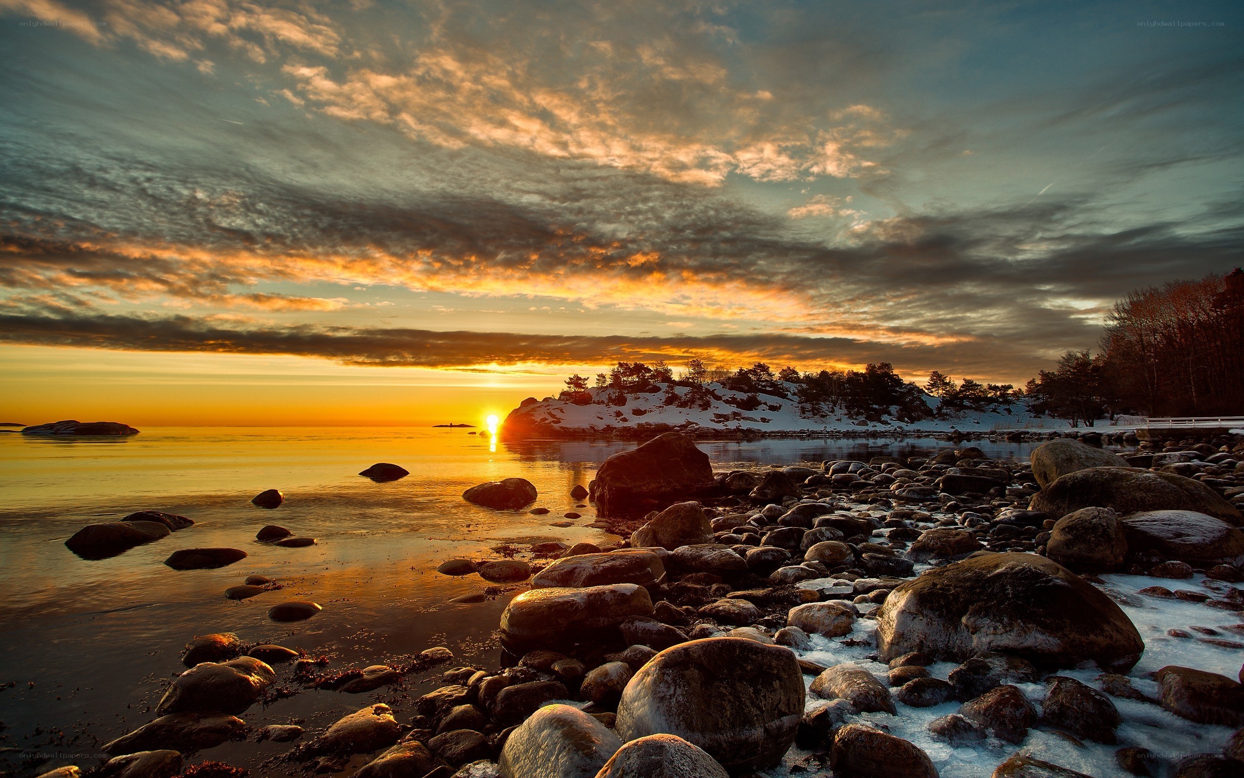Sunset over rocky shoreline