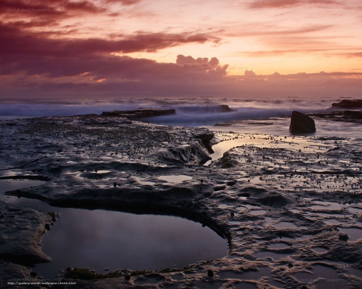 Sunset over rocky shoreline