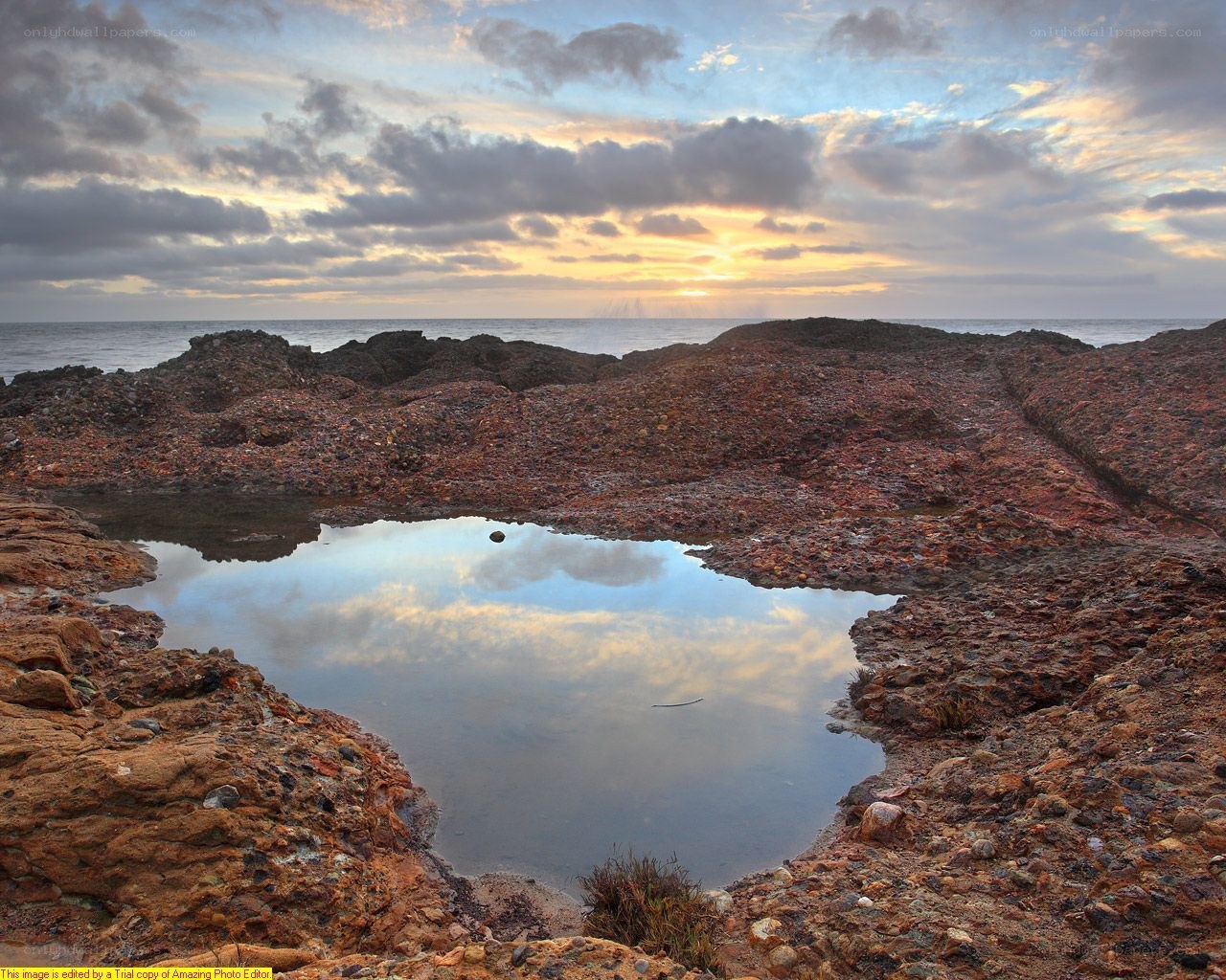 Sunset over rocky tide pool