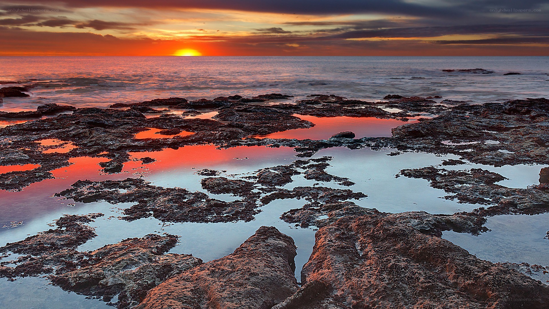 sunset over rocky tide pools