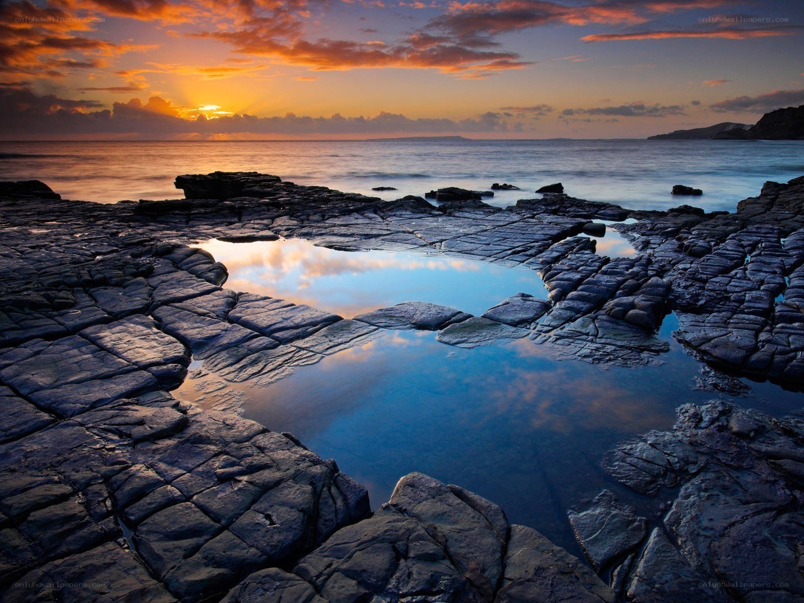 Sunset over rocky tide pools