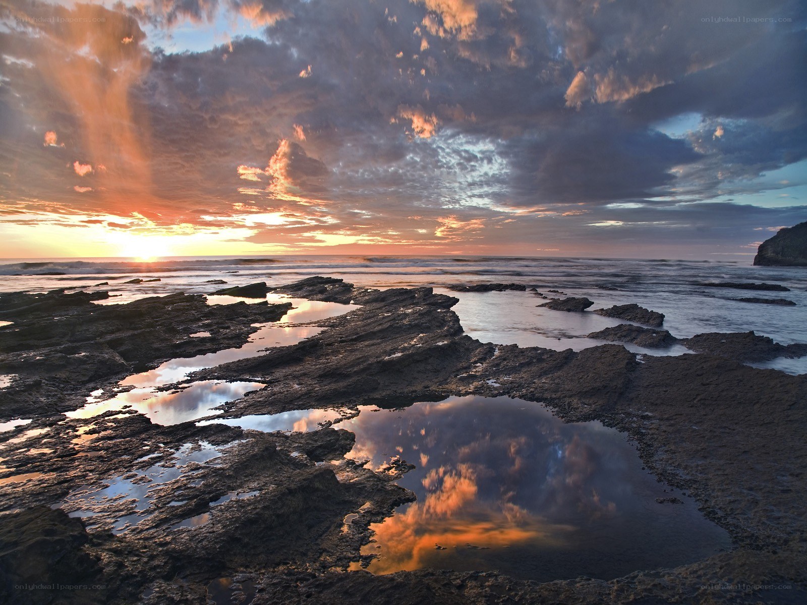 Sunset over rocky tide pools