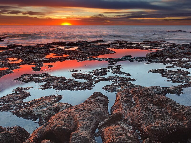 Sunset over rocky tide pools
