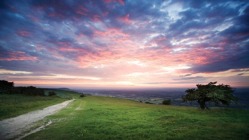 Sunset over rolling green hills