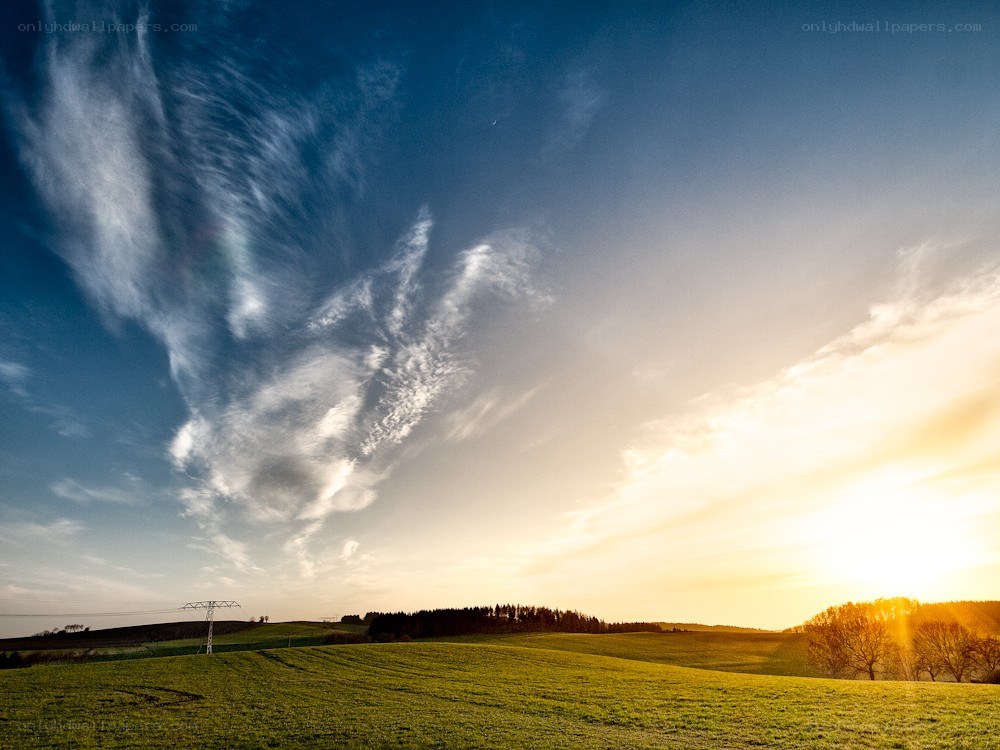Sunset over rolling green hills