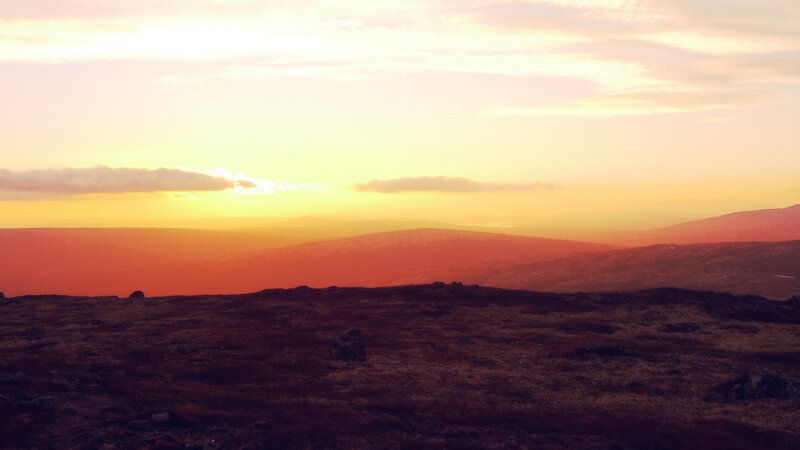 sunset over rolling hills