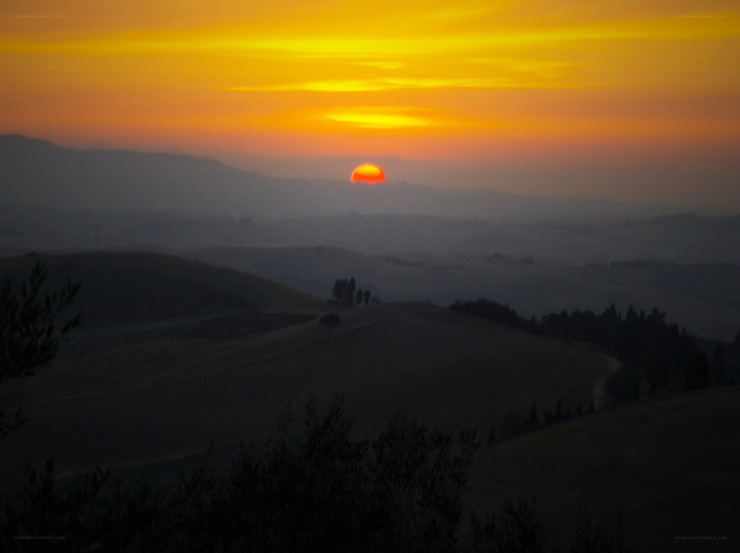 Sunset over rolling hills