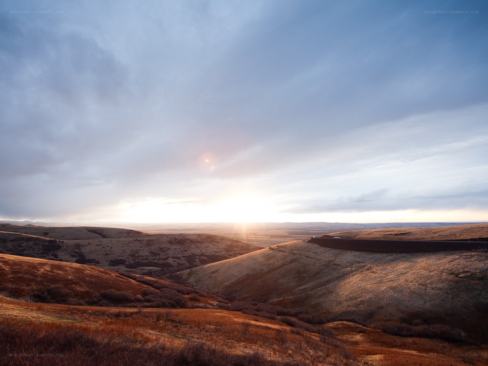 Sunset over rolling hills