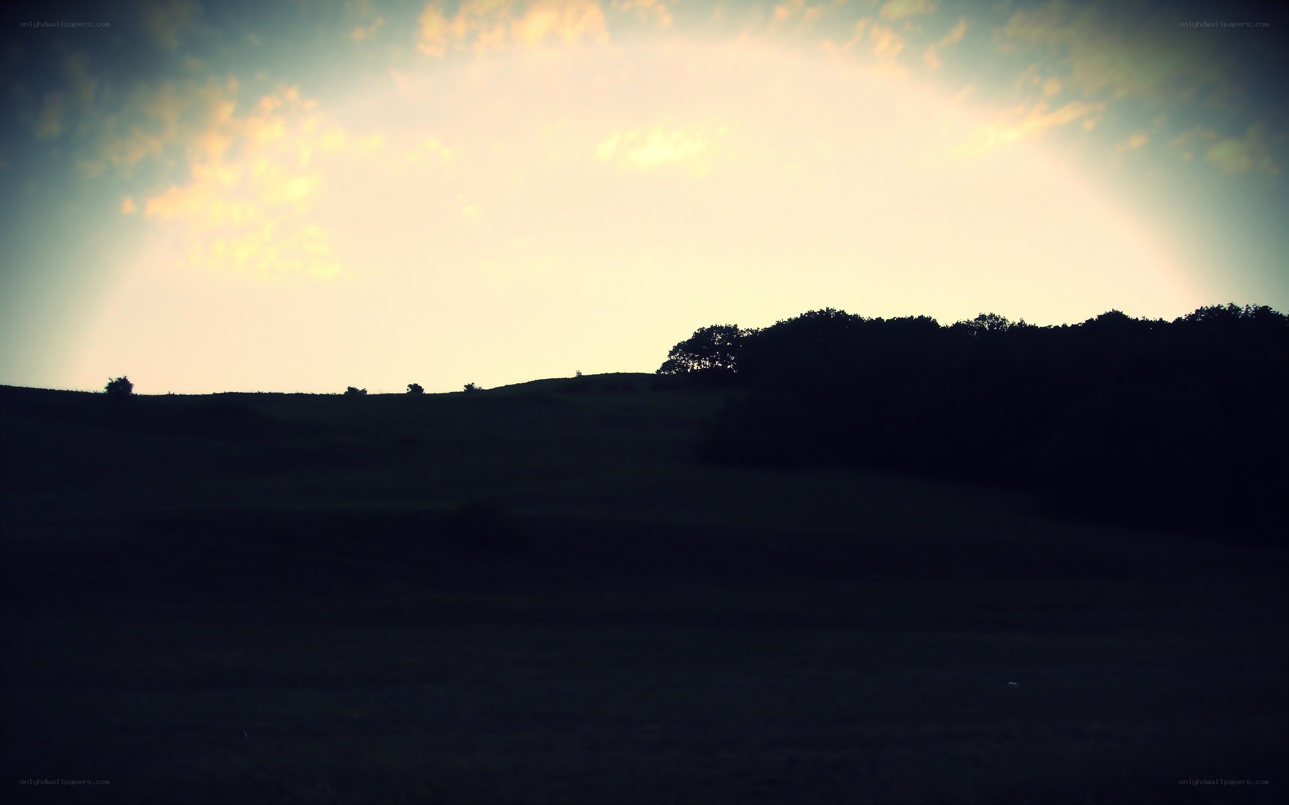 sunset over rolling hills