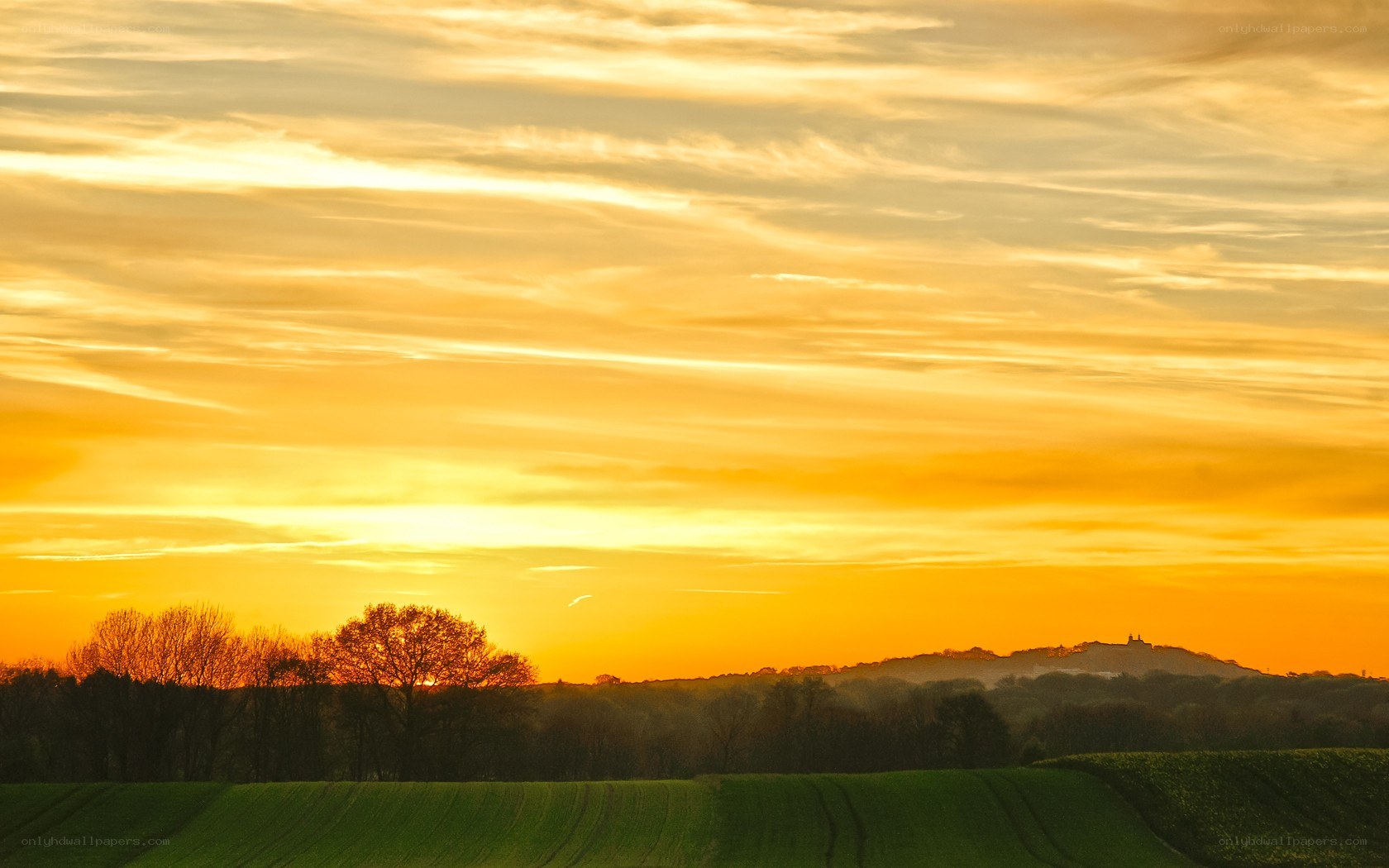 Sunset over rolling hills