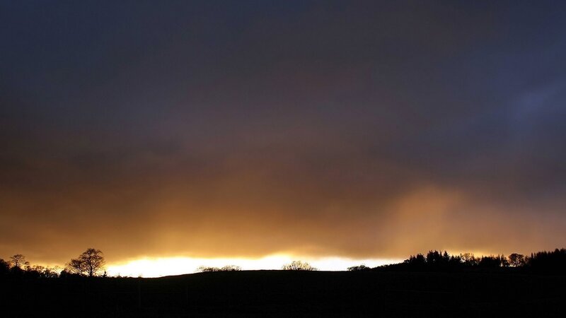 sunset over rolling hills