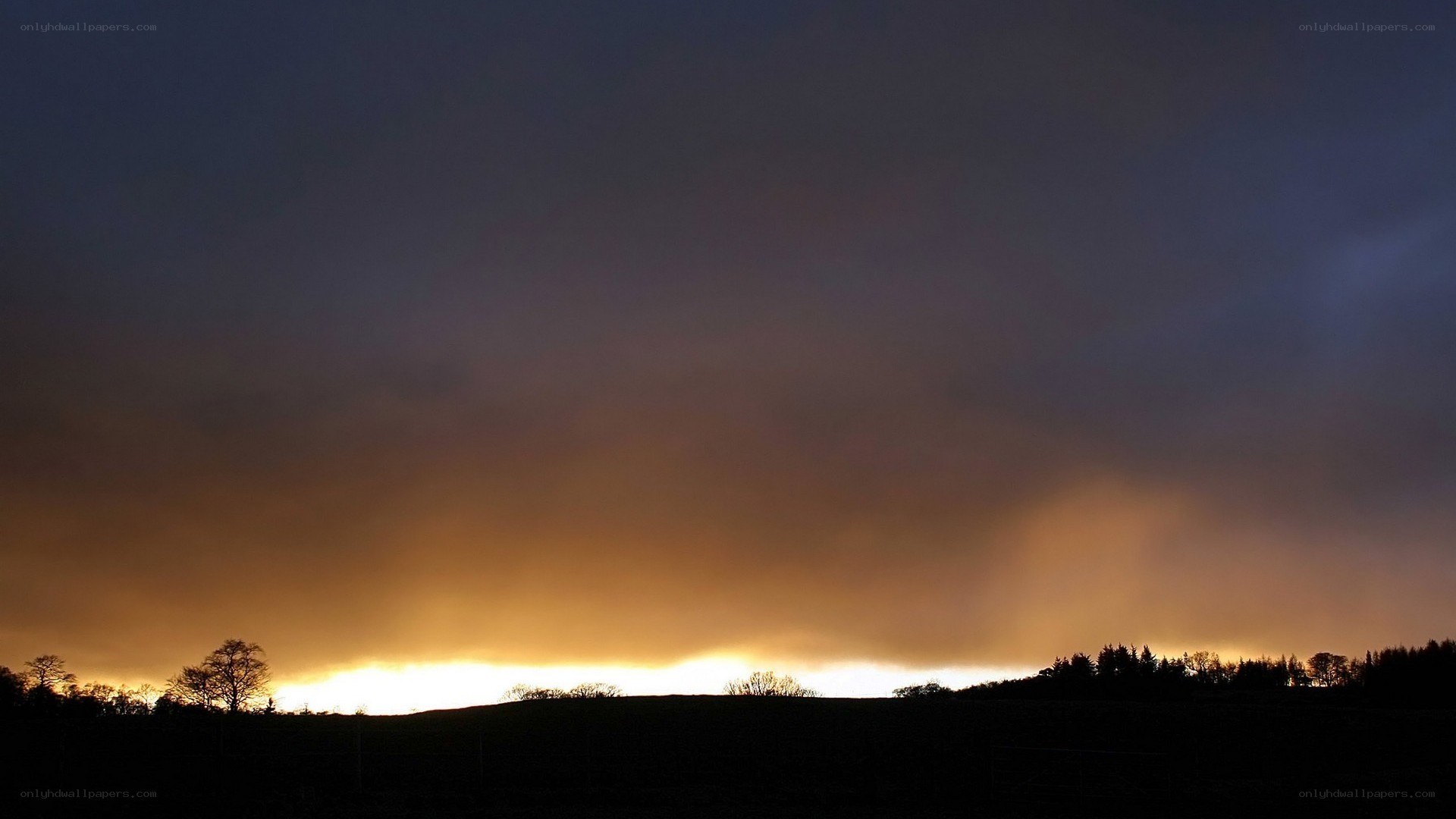 sunset over rolling hills