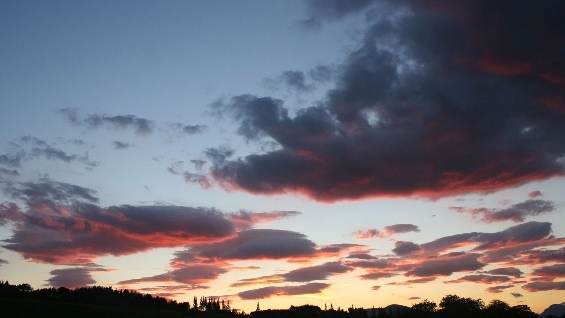 sunset over rolling hills
