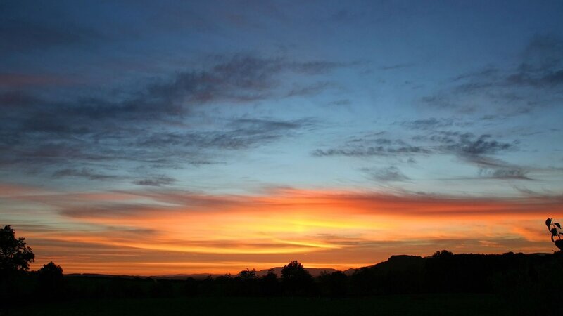 sunset over rolling hills