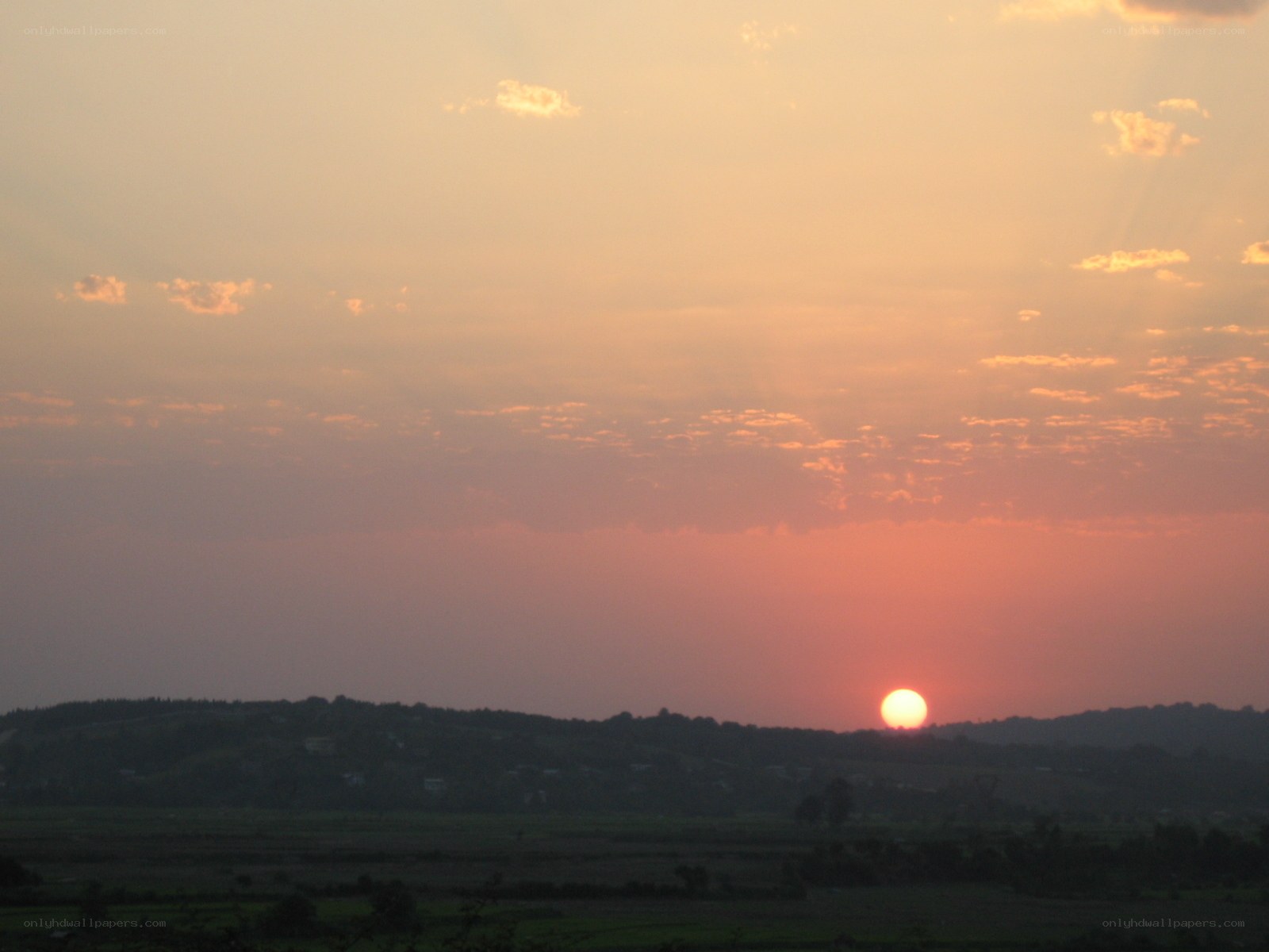 Sunset over rolling hills