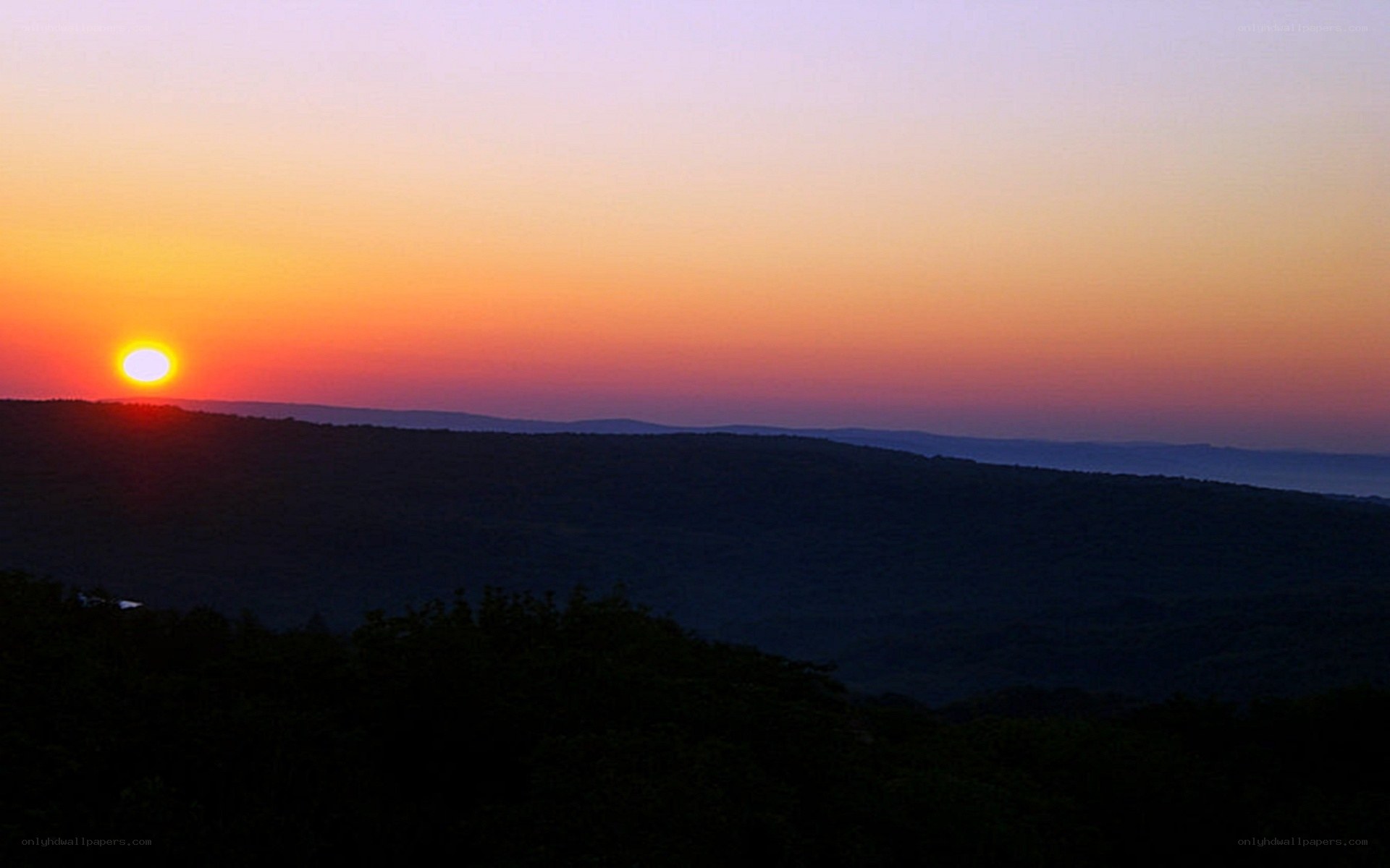 Sunset over rolling hills