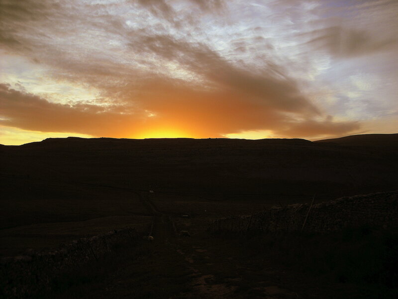 Sunset over rolling hills