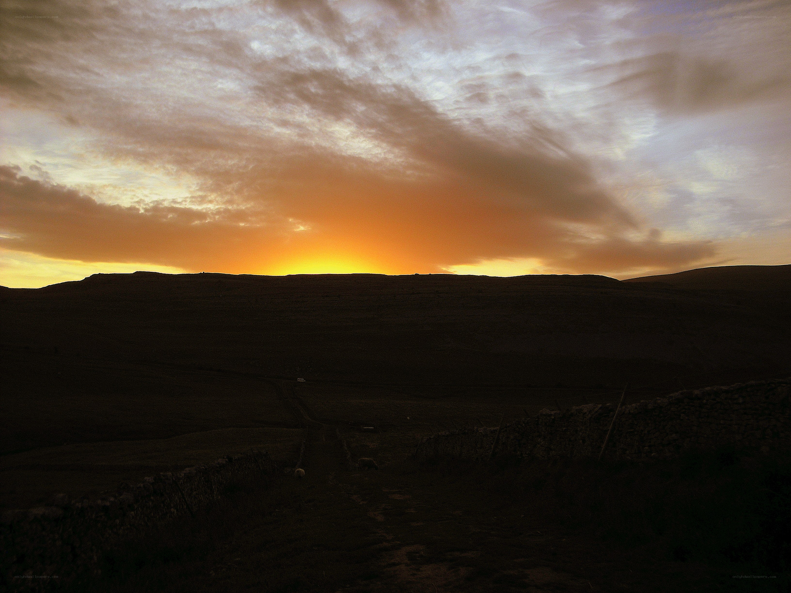 Sunset over rolling hills