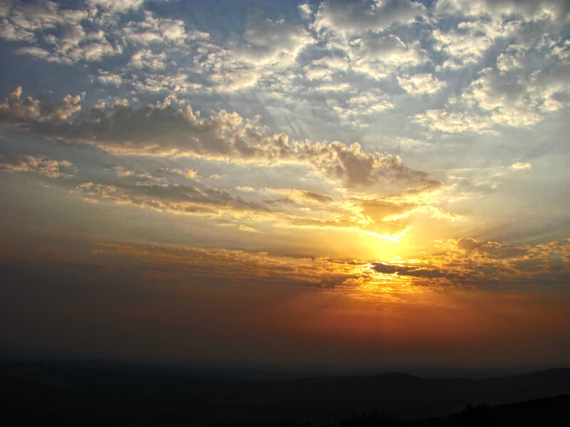 Sunset over rolling hills
