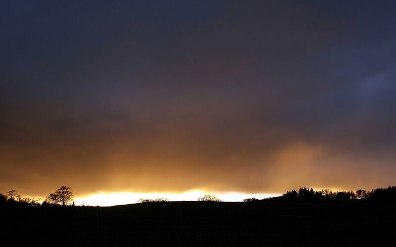sunset over rolling hills