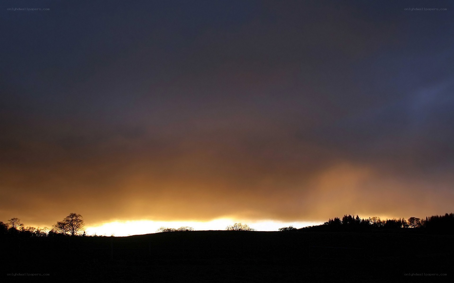 sunset over rolling hills
