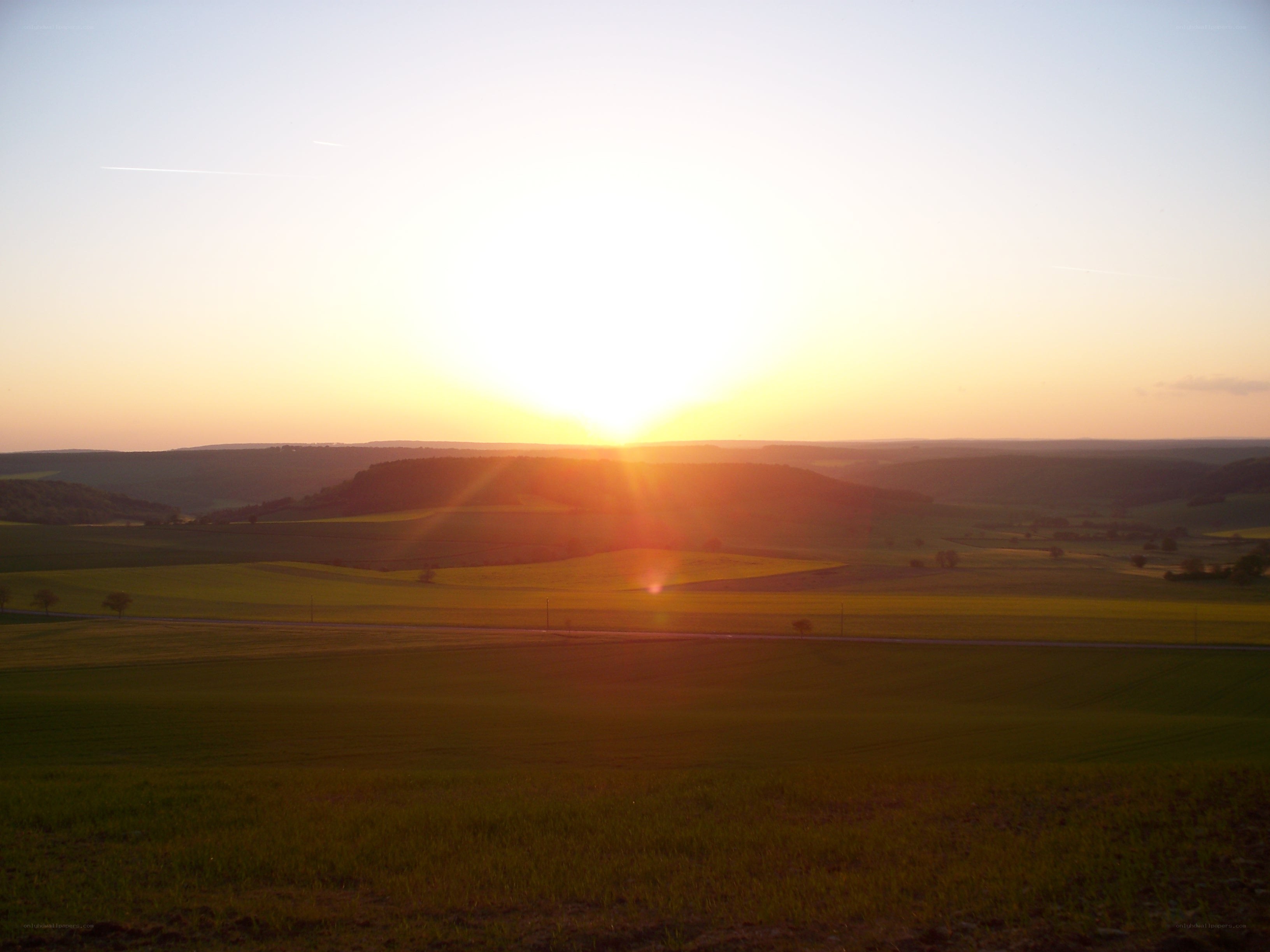 Sunset over rolling hills