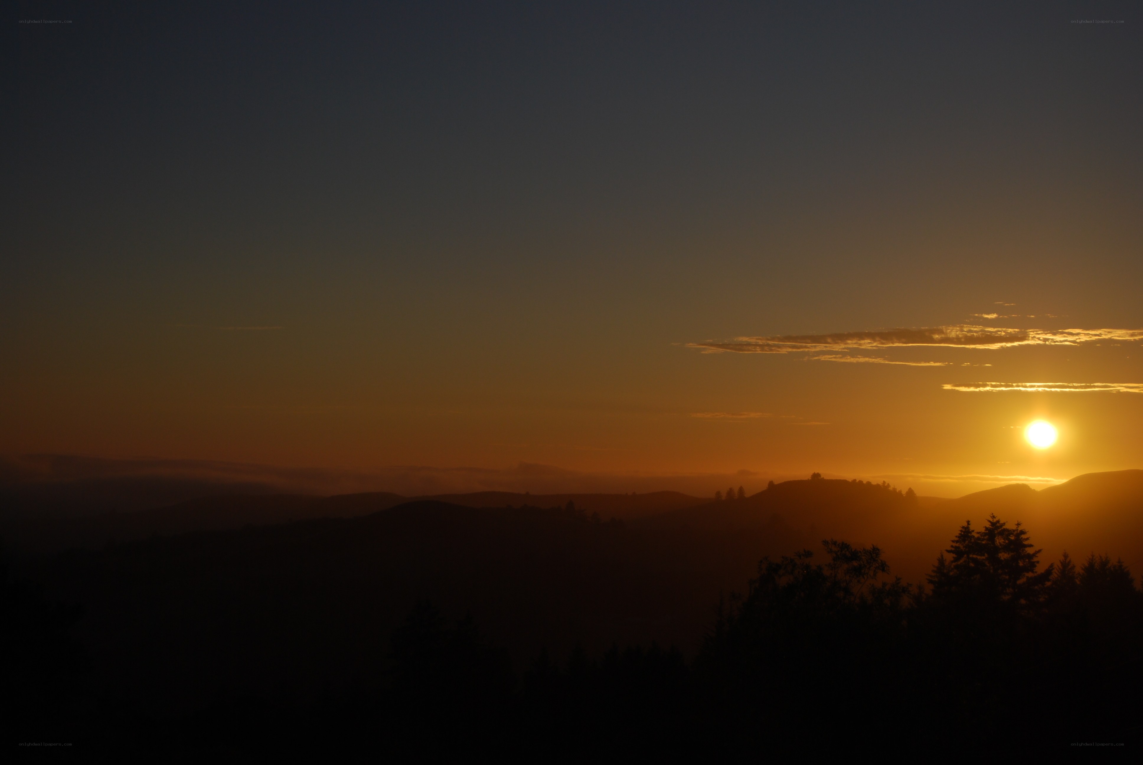 Sunset over rolling hills