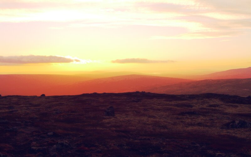 sunset over rolling hills
