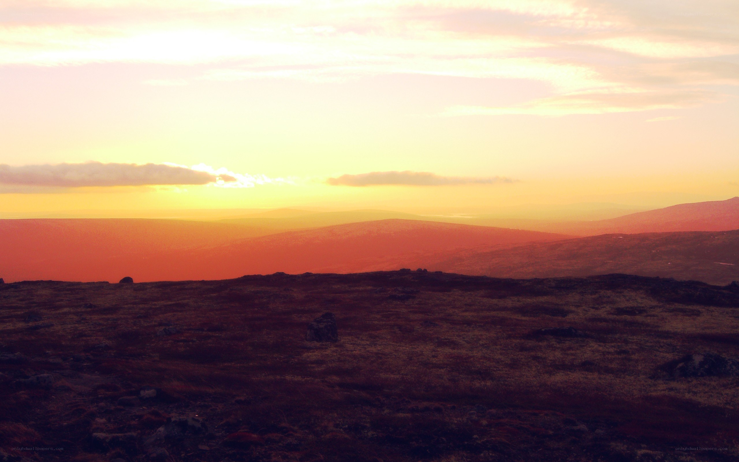 sunset over rolling hills