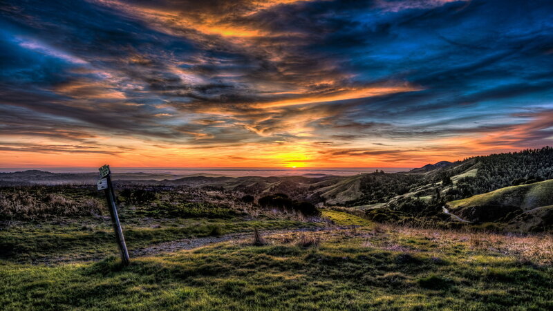 Sunset over Rolling Hills — Orange, Dramatic, Photograph, Sky, Signpost