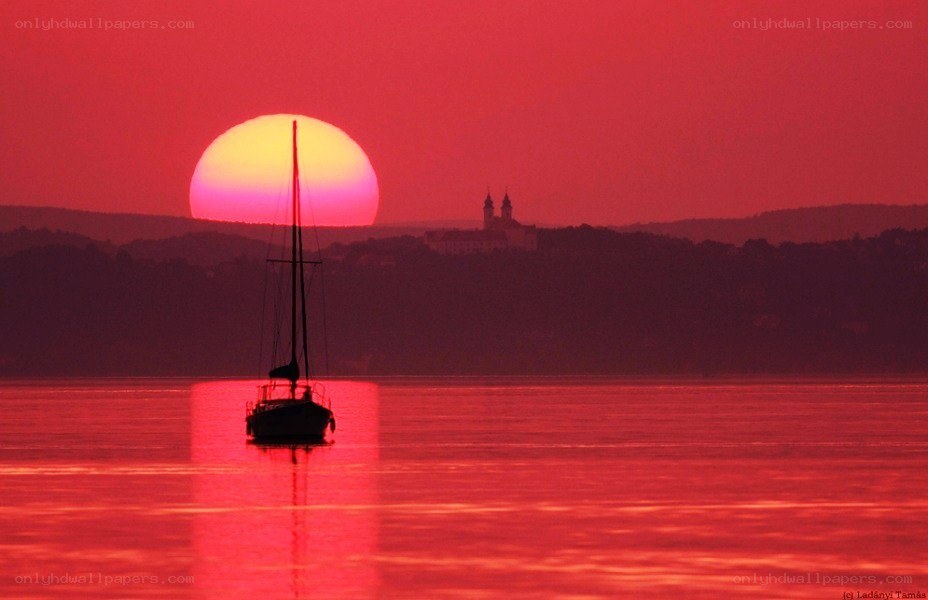 Sunset over sailboat and castle