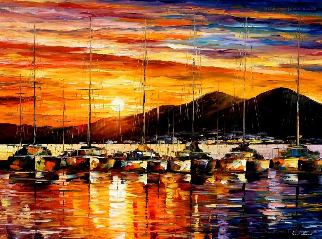 Sunset over sailboats in harbor